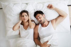 Woman annoyed by her partner snoring